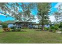 Ranch style home with a large backyard, deck, and pergola at 1420 Anderson St, Clermont, FL 34711