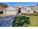 Attractive one-story home with a blue door and well-manicured lawn at 16841 Se 84Th Colerain Cir, The Villages, FL 32162