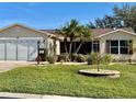 One-story home with a screened patio and lush landscaping at 17483 Se 74Th Netherclift Ter, The Villages, FL 32162