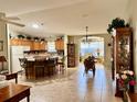 Open kitchen with island, breakfast bar, and ample cabinetry at 17483 Se 74Th Netherclift Ter, The Villages, FL 32162