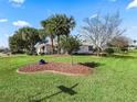Landscaped front yard with palm trees and manicured lawn at 2001 Cordero Ct, The Villages, FL 32159