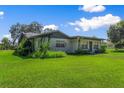 One story home with green lawn and mature trees at 2010 Hollywood Dr, Leesburg, FL 34748