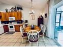 Kitchen dining area with wood table and chairs, offering casual dining at 204 Lori Ct, Umatilla, FL 32784