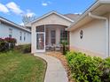 A walkway leads to a screened porch entry at 21122 Lionheart Dr, Leesburg, FL 34748