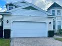 Two-car garage with a white door and a brick paved driveway at 2185 Victoria Dr, Davenport, FL 33837