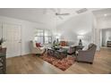 Light-filled living room with hardwood floors and comfy seating at 3257 Kilarny Pl, The Villages, FL 32163