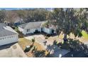 Single story home, birds-eye view of front yard and driveway at 33352 Fountain Ln, Leesburg, FL 34788