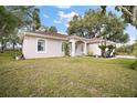 Single story house with mature trees and a large front yard at 34245 Rosa Ln, Fruitland Park, FL 34731