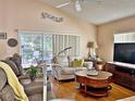 Bright living room with hardwood floors and a view to the patio at 3570 Rollingbrook St, Clermont, FL 34711