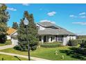 Two-story house with gray roof, purple shutters, and a well-maintained lawn at 3898 Beacon Ridge Way, Clermont, FL 34711