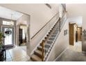 Elegant staircase with white railings leading to the second floor at 3898 Beacon Ridge Way, Clermont, FL 34711