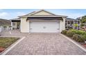 Exterior view of the home's garage and driveway at 392 Arbella Loop, The Villages, FL 32162