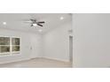 Open concept living room featuring a ceiling fan and lots of natural light at 40210 Orange Cir, Lady Lake, FL 32159