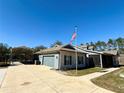 Side view of house showcasing a carport and screened porch at 41913 Cassia St, Eustis, FL 32736