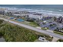 Aerial view showing oceanfront condo complex with tennis courts at 4870 S. Atlantic Ave, # 2040, New Smyrna Beach, FL 32169