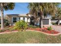 House exterior with palm trees and a brick driveway at 4992 Big Cypress St, Oxford, FL 34484