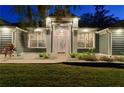 Gray house exterior with white columns, illuminated at night at 5055 County Road 125 # B1, Wildwood, FL 34785