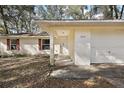 Single story home with a carport and mature landscaping at 5870 Se 158Th Ct, Ocklawaha, FL 32179