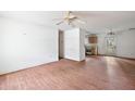 Living room with laminate floors and a view into the kitchen at 5870 Se 158Th Ct, Ocklawaha, FL 32179