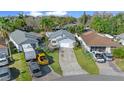 Aerial view of a single-story home with a long driveway and mature trees at 7 Ginger Cir, Leesburg, FL 34748