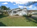 Charming single-story home with a one-car garage, well-maintained lawn, and mature landscaping at 7 Ginger Cir, Leesburg, FL 34748