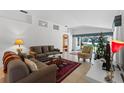 Bright living room with comfy sofas, a Christmas tree, and tiled floors at 7023 Arcadian Ct, Mount Dora, FL 32757