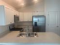 Modern kitchen featuring stainless steel appliances and white cabinets at 7268 Annison Ter, The Villages, FL 32163