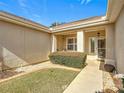 Front entry courtyard with walkway, landscaping, and seating area at 9397 Se 124Th Pl, Summerfield, FL 34491