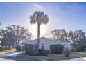 Lovely single-story home with manicured landscaping and a symmetrical facade nestled amongst trees at 1204 Maria Ct, Lady Lake, FL 32159