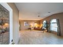 Bright living room with a high ceiling, arched windows, and a comfortable leather sofa at 1204 Maria Ct, Lady Lake, FL 32159