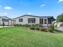 Front view of a single story home with a carport and well-maintained lawn at 1210 Tarpon Ln, The Villages, FL 32159