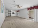 Spacious living room with carpet and view to kitchen at 1303 E Schwartz Blvd, The Villages, FL 32159