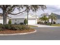 Charming single-story home with a well-manicured lawn and mature trees at 1541 Fenimore Ln, The Villages, FL 32162