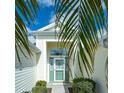 Inviting front entry with a green door, sidelights, and brick pathway at 1541 Fenimore Ln, The Villages, FL 32162