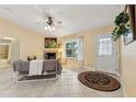 Bright living room with fireplace, tiled floors, and access to other rooms at 15831 Se 89Th Ter, Summerfield, FL 34491