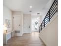 Bright and airy entryway with light wood floors and modern staircase at 16254 Ravenna Ct, Bella Collina, FL 34756