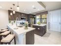 Modern kitchen with stainless steel appliances, granite countertops, island and breakfast bar at 16300 County Road 455 # 414, Bella Collina, FL 34756