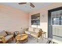 Enclosed porch featuring comfortable seating and an exterior door at 17461 Se 93Rd Retford Ter, The Villages, FL 32162