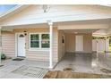 Front entryway with carport and white door at 1805 Jefferson Dr, Mount Dora, FL 32757