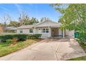 Tan house with carport, landscaping, and a spacious front yard at 1805 Jefferson Dr, Mount Dora, FL 32757