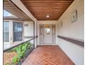 Covered entryway with tile flooring and a glass door at 21524 Queen Anne Ct, Leesburg, FL 34748