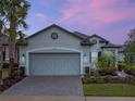 Beautiful two-story home with a gray exterior, two-car garage, and manicured landscaping at 2597 Mariotta Rdg, Clermont, FL 34715