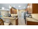 Kitchen with granite countertops, stainless steel appliances, and wood cabinets at 26715 Manassas Dr, Leesburg, FL 34748