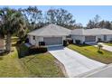 Two-unit property featuring identical houses with garages and neatly kept lawns at 26912 Tanner St, Leesburg, FL 34748