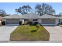 Three-unit property with attached garages and a shared driveway at 26912 Tanner St, Leesburg, FL 34748