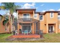 Screened patio with table and chairs, adjacent to a two-story townhome at 2713 Impala Ln, Kissimmee, FL 34746