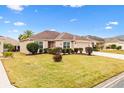 One story house with a two car garage and manicured lawn at 2954 Silk Tree Ter, The Villages, FL 32163