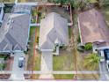 Aerial view of a green house and surrounding neighborhood at 30111 Pga Dr, Mount Plymouth, FL 32776