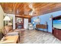 Living room with wood-paneled ceiling and comfy leather recliner at 32125 Mark Ave, Tavares, FL 32778