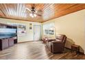 Living room with wood ceiling, fireplace, and leather recliner at 32125 Mark Ave, Tavares, FL 32778